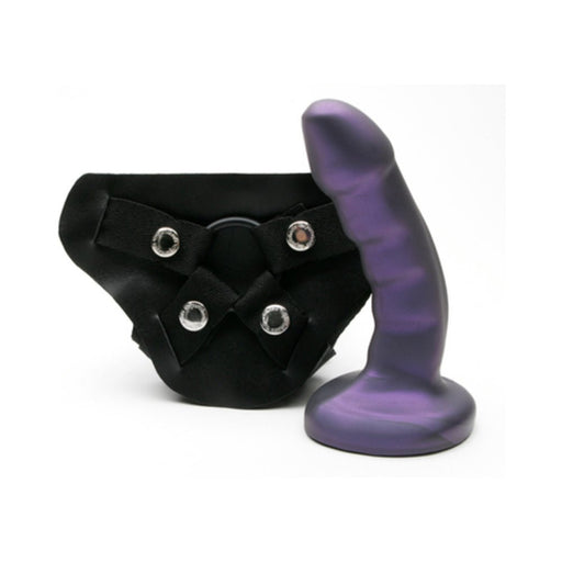 Midnight purple curved silicone dildo with black adjustable strap-on harness set on white background.