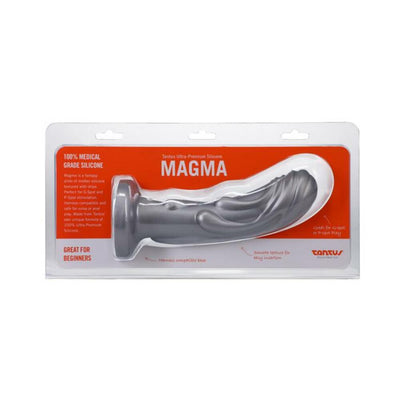 Silver Tantus Magma 7-inch fantasy dildo in clear packaging with orange background, featuring textured design and harness compatible base.