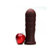 Large dark brown silicone anal plug standing next to a red apple for size comparison on a white background.
