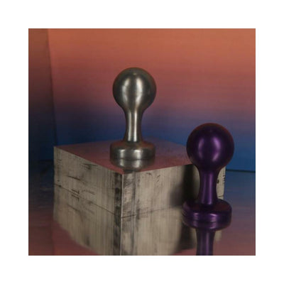 Silver and purple metallic orb-shaped adult toys displayed on a reflective surface with a gradient background.