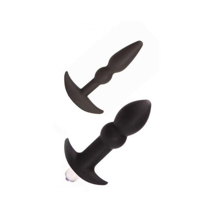 Two black silicone anal plugs, one slender and one larger with a removable vibrator, both with flared bases.