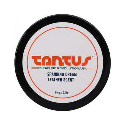 Top view of Tantus Apothecary Spanking Cream in leather scent, 8 oz container with black lid and white label.