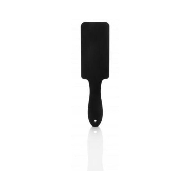 Black silicone paddle with ergonomic handle and rectangular striking surface, designed for durable and hygienic use.