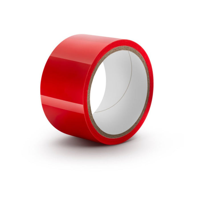 Roll of glossy red self-adhesive bondage tape on white background