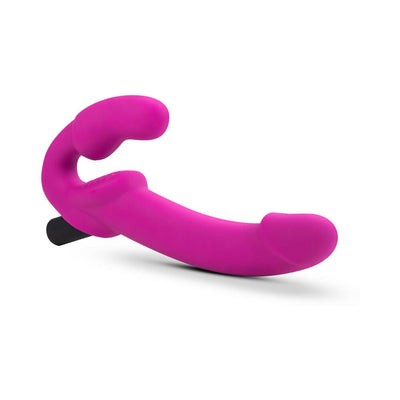 Pink strapless silicone dildo with ergonomic curved design and vibrating bullet, designed for targeted stimulation.