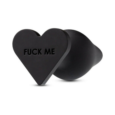 Black silicone butt plug with a heart-shaped base embossed with bold text, smooth matte finish.