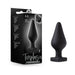 Black silicone Temptasia butt plug with heart-shaped base and packaging showing product details.