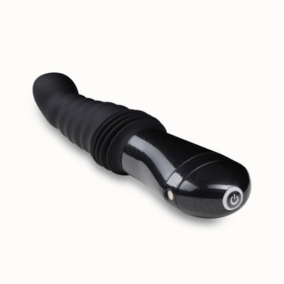 Black Temptasia Lazarus thrusting dildo with ribbed curved shaft and ergonomic handle with power button.