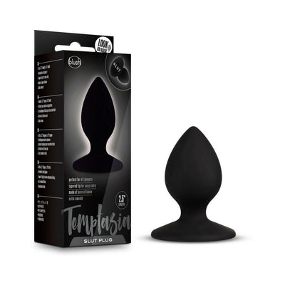 Black silicone Temptasia Slut Butt Plug with tapered tip and round base next to its sleek black packaging.
