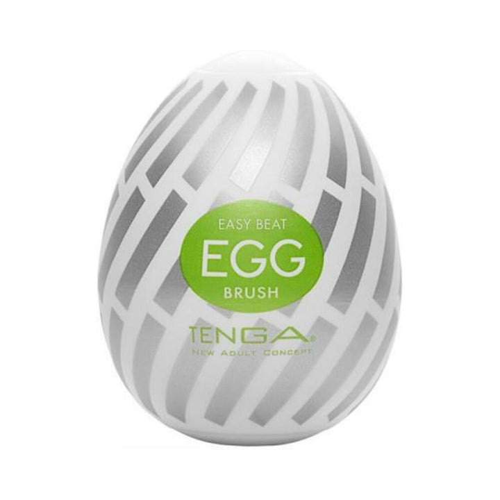 Compact white and silver patterned Tenga EGG Brush with green label, designed for discreet and portable use.