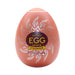 Tenga EGG Shiny II in orange egg-shaped casing with silver sunburst design and bold yellow text on front.
