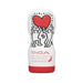 Tenga Original Vacuum Cup with Keith Haring artwork featuring two figures holding a red heart on a white and red container.