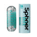 Tenga Spinner Pixel male pleasure device with clear textured sleeve and light blue packaging featuring spiral design.