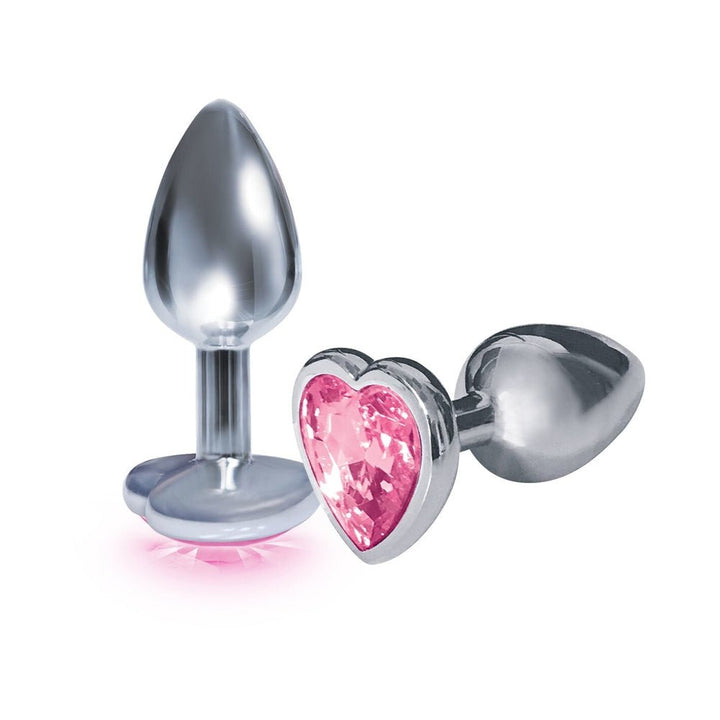 Stainless steel beginner-sized butt plug with a pink heart-shaped jeweled base, shown standing and lying down.
