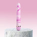 Pink and white marbled vibrator standing upright on a round marble pedestal with a soft pink gradient background.