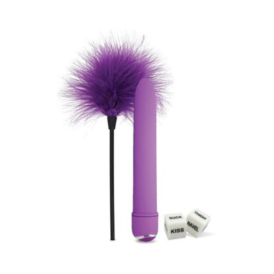 Purple feather tickler, sleek purple waterproof massager, and two white erotic love dice on white background.