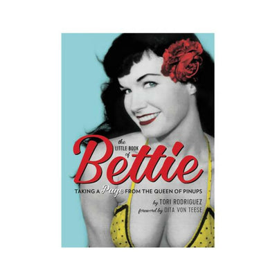 Cover of The Little Book of Bettie featuring a vintage-style photo of Bettie Page with a red flower in her hair and retro yellow polka dot top.