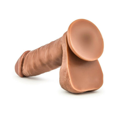 Realistic tan silicone dildo with suction cup base and lifelike texture, designed for versatile use.