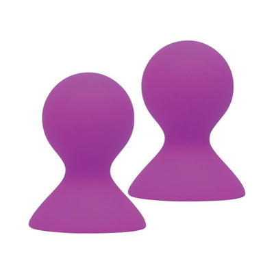 Pair of violet silicone nipple pumps with rounded tops and wide bases for gentle suction stimulation.