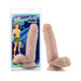 Beige realistic dildo with suction cup base next to packaging featuring cartoon surfer character and product details.
