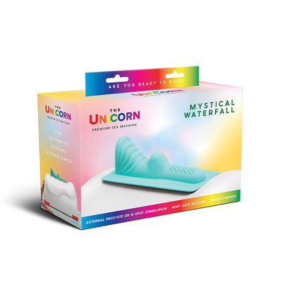 The Unicorn Mystical Waterfall silicone attachment in teal with textured design, displayed in colorful branded packaging.