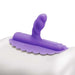 Purple silicone Uni Horn attachment with angled textured head and studded base for targeted stimulation on white surface.
