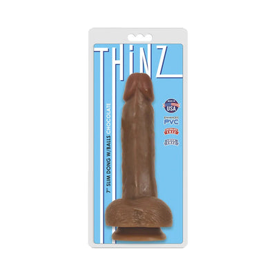 Chocolate-colored 7-inch slim realistic dong with balls in clear retail packaging on blue background.