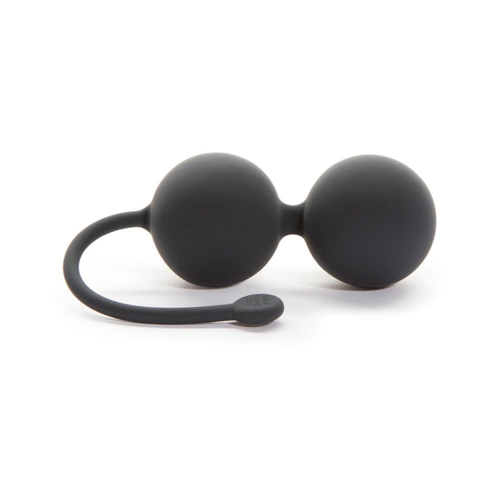 Black silicone dual Kegel balls with flexible retrieval cord for pelvic floor strengthening exercises.
