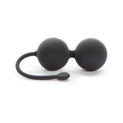 Black silicone dual Kegel balls with flexible retrieval cord for pelvic floor strengthening exercises.