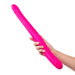 Hand holding a long, flexible, bright pink silicone dual-ended intimate toy with rounded tips.