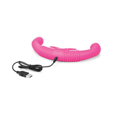 Pink curved dual-arm intimate toy with ribbed texture and USB charging cable on white background.