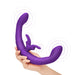 Hand holding a purple flexible dual-arm intimacy toy with dual external stimulators and vibration indicators.