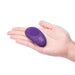 Hand holding a compact purple remote control for the Together Toy with simple button design and logo.