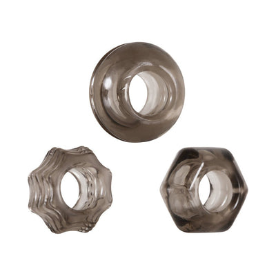 Set of three smoke-colored thick cock rings in circle, star, and hexagon shapes with textured designs.