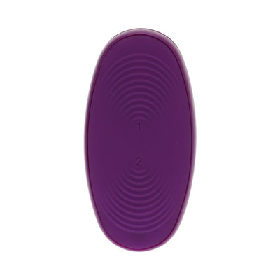 Purple oval remote control with textured buttons labeled 1 and 2 for Tryst V2 massager settings.
