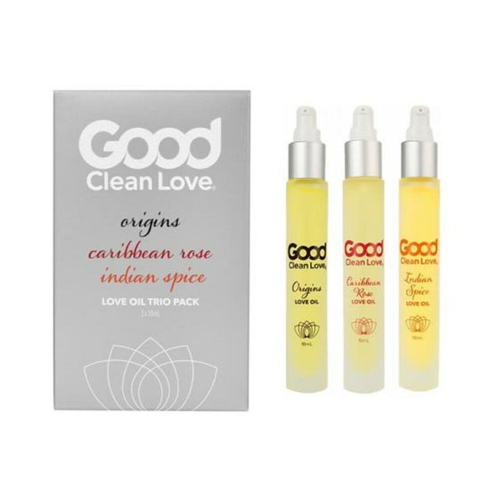 Good Clean Love Origins Love Oil Trio Pack with Caribbean Rose and Indian Spice scents in 10ml spray bottles next to gray packaging box.