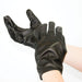 Black leather gloves with small metal tacks on fingertips, worn on hands against a white background.