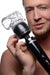 Man holding a black massage wand with a clear Vibra-stroke Masturbator attachment on the head.