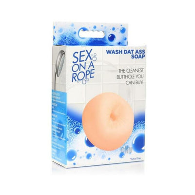 Packaging of Wash Dat Ass Soap On A Rope with peach-colored soap shaped like a puckered circle and blue bubble design background.