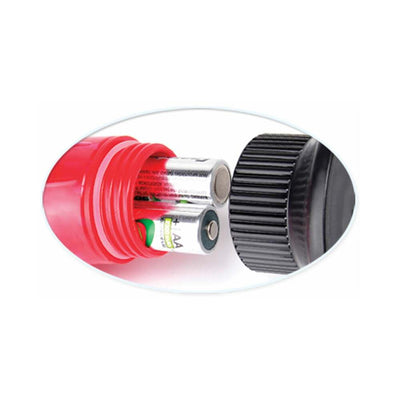 Close-up of pink vibrator battery compartment showing two AA batteries inside with black screw-on cap removed.