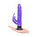 Hand holding a purple waterproof vibrator with suction base and clitoral stimulator attachment.