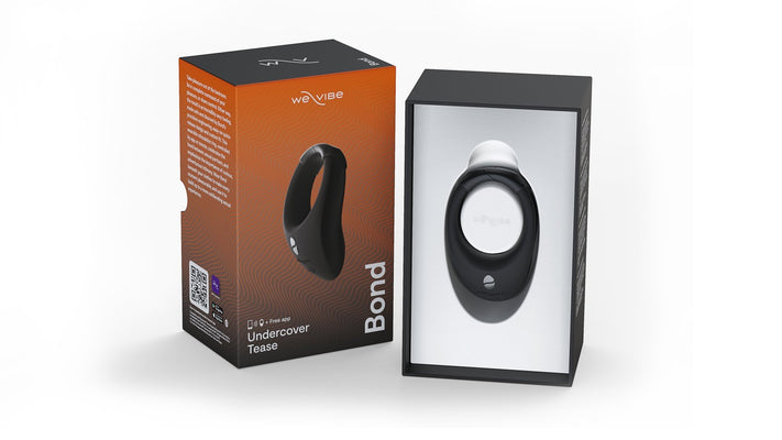 We-Vibe Bond remote-controlled wearable vibrating ring in charcoal black with packaging box showing product image and app compatibility details.