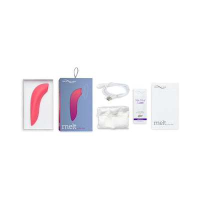 We-Vibe Melt clitoral stimulator in pink with packaging, USB charging cable, satin storage pouch, lubricant sample, and user manual.