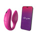 Pink We-Vibe Sync couples vibrator with textured silicone and smartphone displaying We-Vibe app interface.