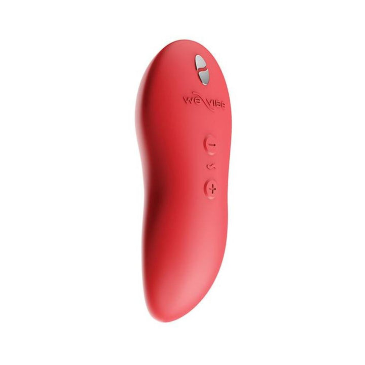 We-Vibe Touch X ergonomic handheld vibrator in coral red with smooth silicone finish and three control buttons.