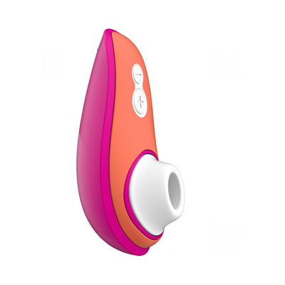 Compact Womanizer Liberty clitoral stimulator in pink and orange with white silicone head and control buttons.