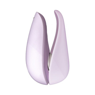 Compact Womanizer Liberty clitoral stimulator in soft lavender with sleek, ergonomic design and dual curved arms.