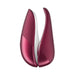 Compact Womanizer Liberty clitoral stimulator in deep red with sleek, ergonomic design and two interchangeable heads.