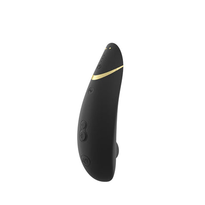 Black Womanizer Premium 2 clitoral stimulator with gold accent and multiple control buttons on a white background.