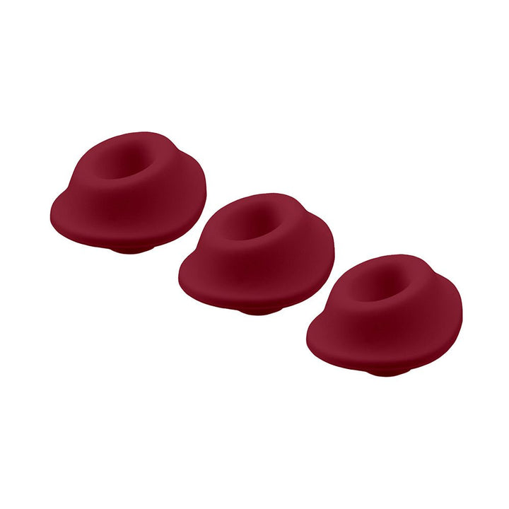 Three Bordeaux-colored silicone replacement heads for Womanizer Premium and Classic models on white background.